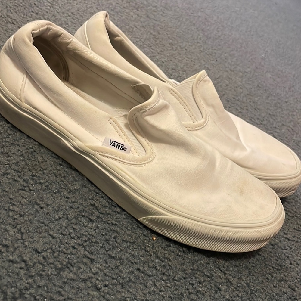 Slightly worn white slip on vans